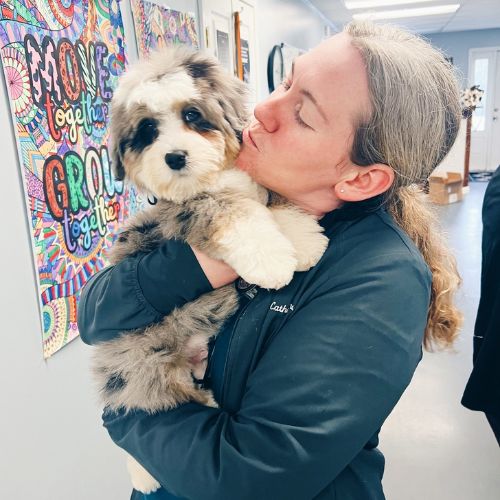 A woman holds a dog in a cozy